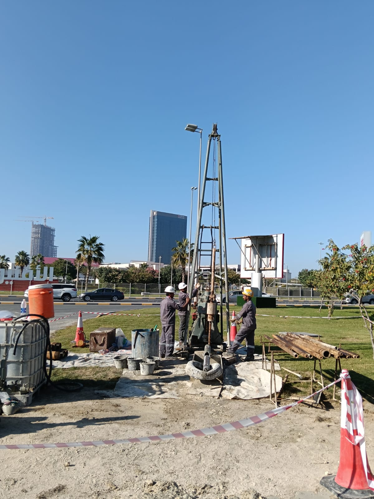 QEL technician operating a portable drilling rig during onshore site investigation
